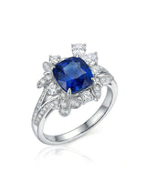 Cushion-cut royal blue sapphire ring with floral diamond halo in platinum | SARATTI