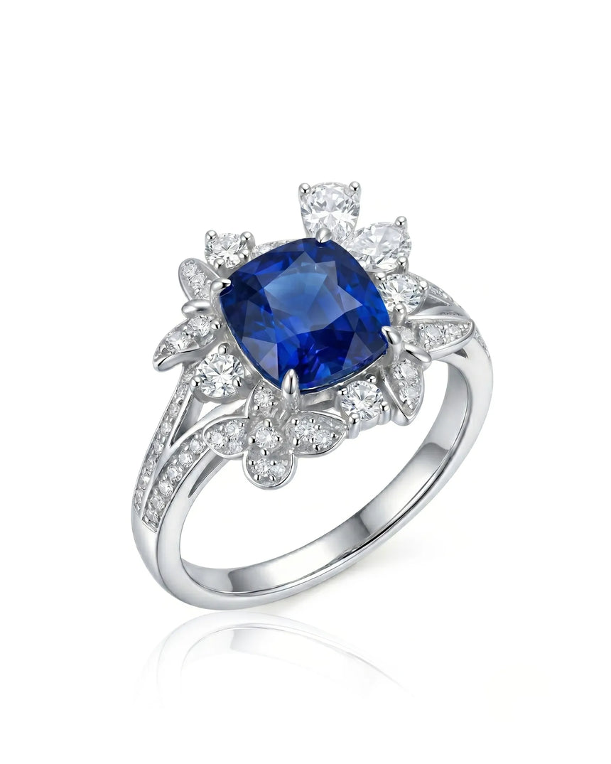 Cushion-cut royal blue sapphire ring with floral diamond halo in platinum | SARATTI