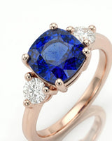 Cushion blue sapphire ring with two round diamonds in 18K rose gold | SARATTI