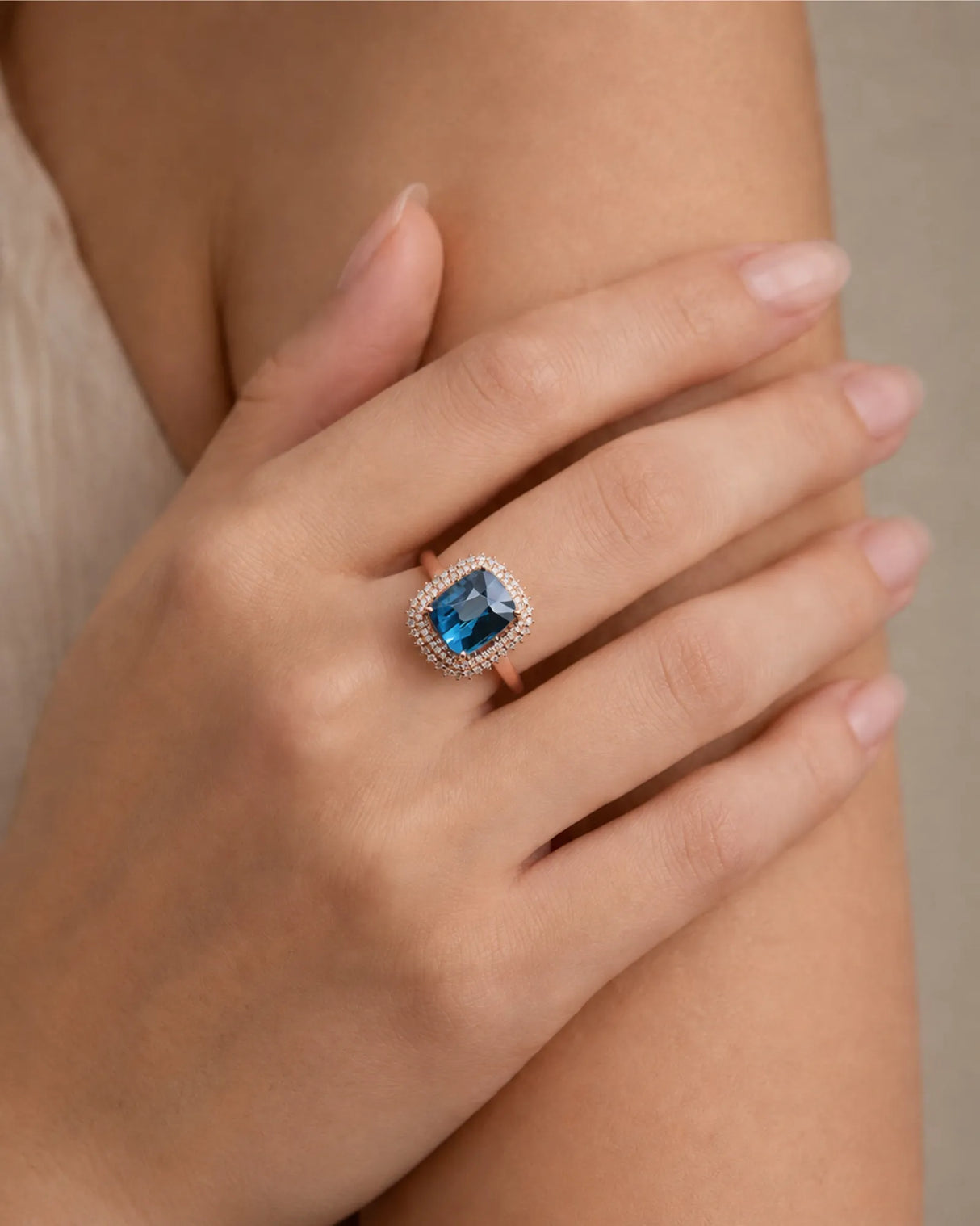 Cushion blue tourmaline ring with round brilliant diamonds and romantic rose gold setting | SARATTI
