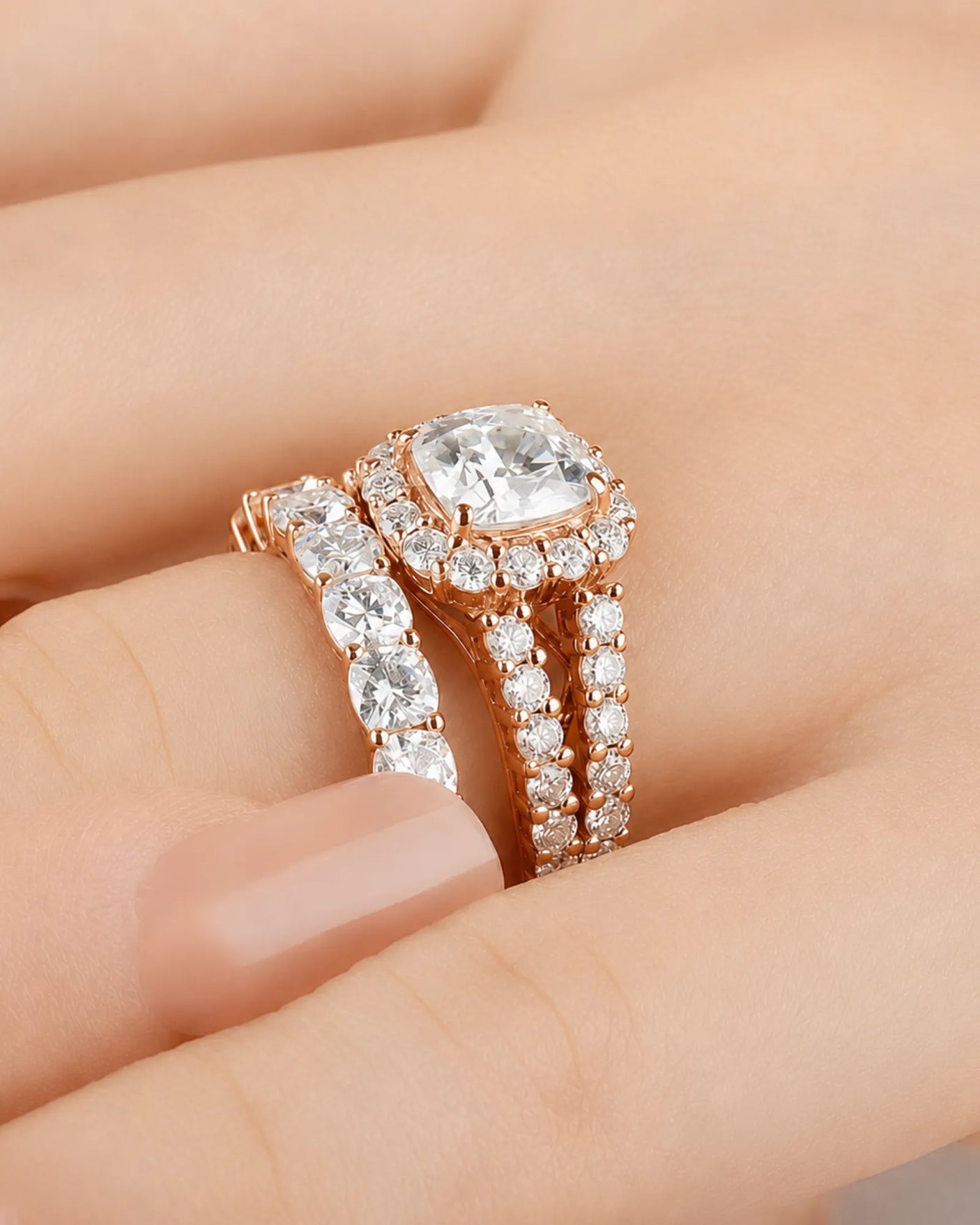 Cushion moissanite bridal set in rose gold with round halo accents and divided shoulders | SARATTI