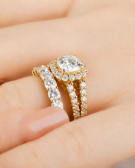 Cushion moissanite bridal set in yellow gold with round halo accents and divided shoulders | SARATTI