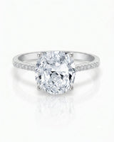 Cushion moissanite center stone ring with round side stones in platinum | SARATTI