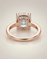 Cushion moissanite center stone ring with round side stones in rose gold | SARATTI