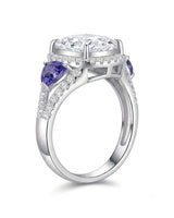 Cushion moissanite center stone ring with trillion tanzanites in platinum | SARATTI