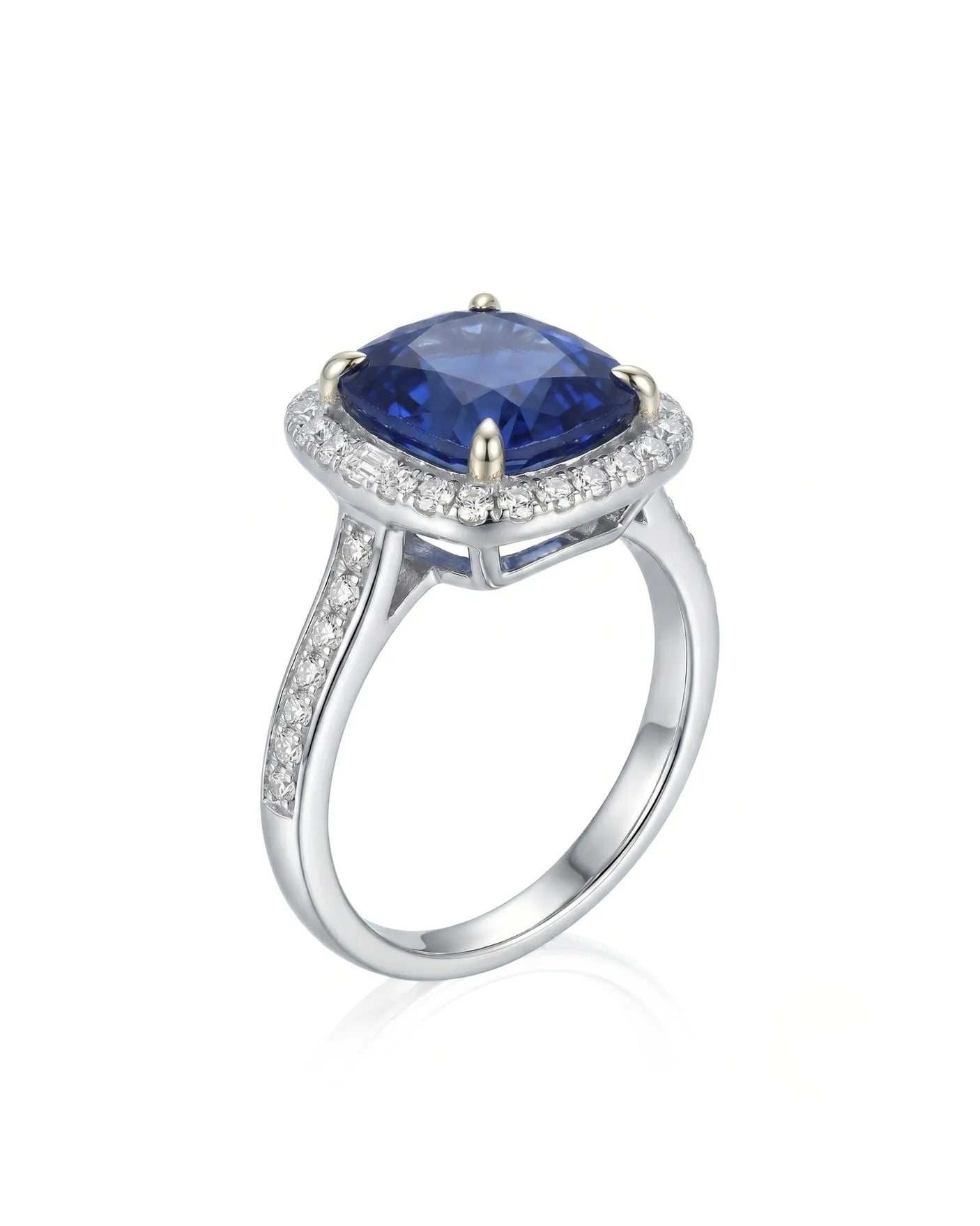 Cushion royal blue sapphire ring with diamond halo and shoulder stones in 18K white gold | SARATTI