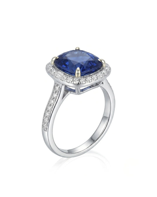Cushion royal blue sapphire ring with diamond halo and shoulder stones in 18K white gold | SARATTI