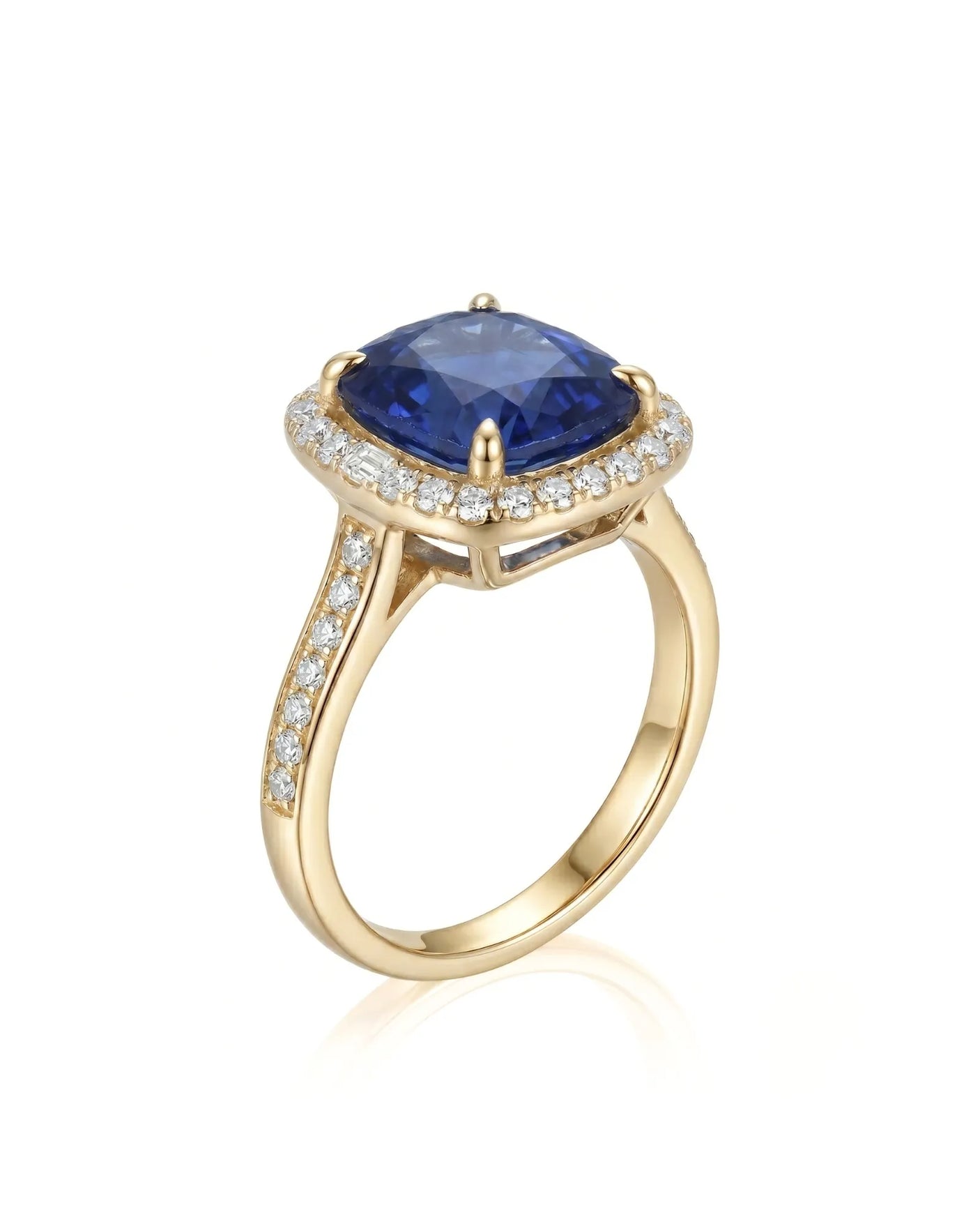 Cushion royal blue sapphire ring with diamond halo and shoulder stones in 18K yellow gold | SARATTI