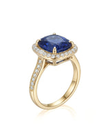 Cushion royal blue sapphire ring with diamond halo and shoulder stones in 18K yellow gold | SARATTI