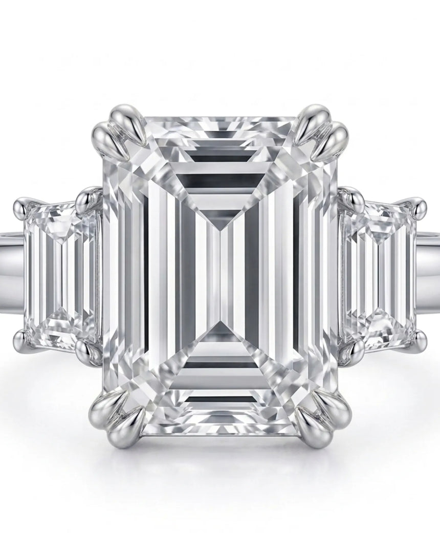 D color emerald cut moissanite center with matching side stones in 18K white gold | SARATTI