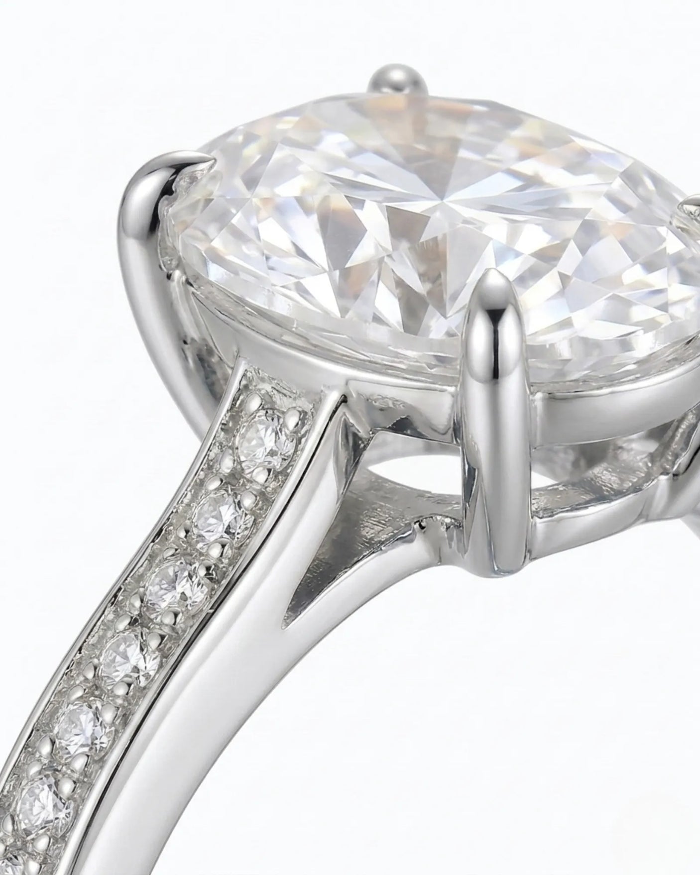 D color oval moissanite center framed by round accents in polished platinum | SARATTI