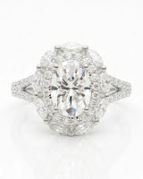 D color oval moissanite center framed by round and marquise stones in polished platinum | SARATTI