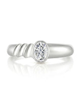 D color oval moissanite framed by a smooth bezel in refined 18K white gold | SARATTI