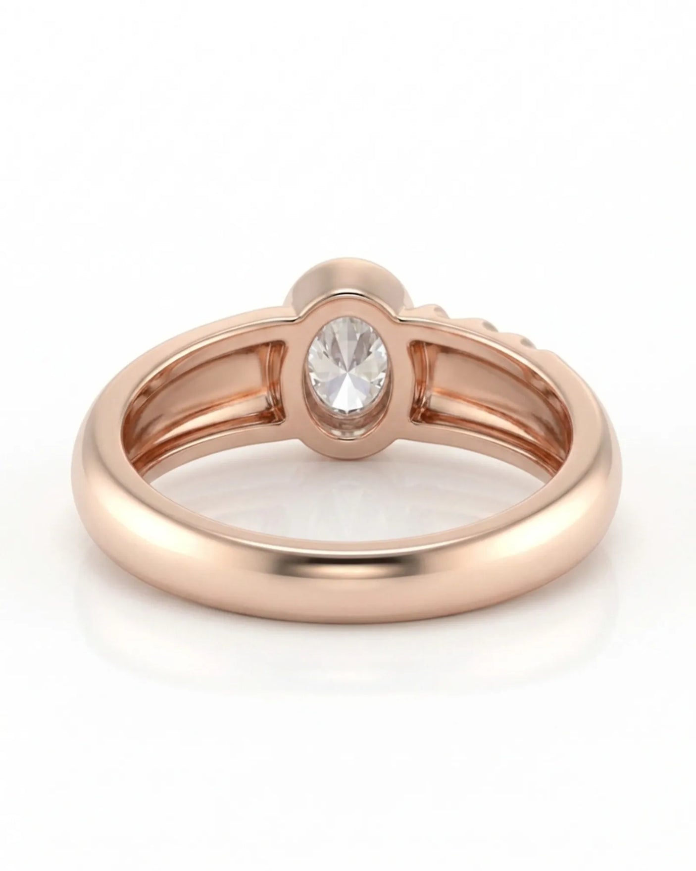 D color oval moissanite framed by a smooth bezel in softly polished 18K rose gold | SARATTI