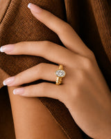 D color oval moissanite framed by a smooth bezel in warm 18K yellow gold | SARATTI