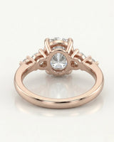 D color oval moissanite framed by round side stones in polished 18K rose gold | SARATTI