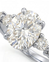 D color oval moissanite framed by round side stones in polished platinum | SARATTI