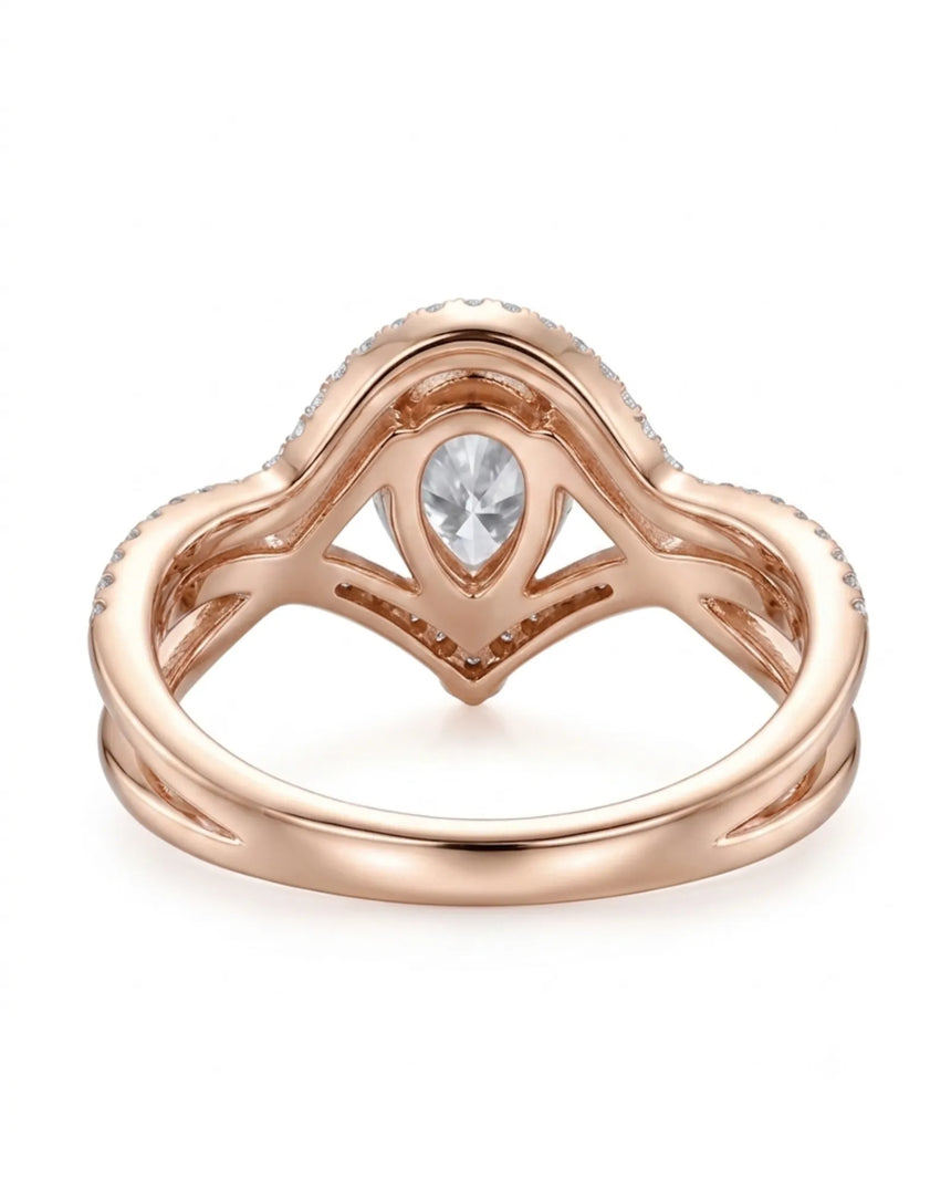 D color pear-shaped moissanite framed by round accent stones in softly polished rose gold | SARATTI
