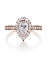D color pear moissanite center framed by round accents in polished 18K rose gold | SARATTI