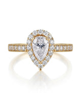 D color pear moissanite center framed by round accents in polished 18K yellow gold | SARATTI