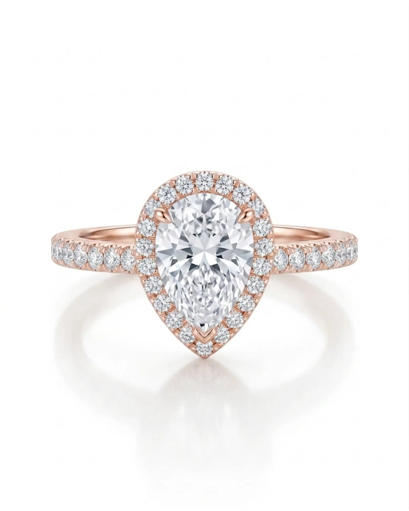 D color pear moissanite center framed by round accents in softly polished 18K rose gold | SARATTI
