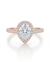 D color pear moissanite center framed by round accents in softly polished 18K rose gold | SARATTI