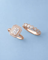 D color radiant moissanite center framed by round moissanite accents in polished 18K rose gold | SARATTI