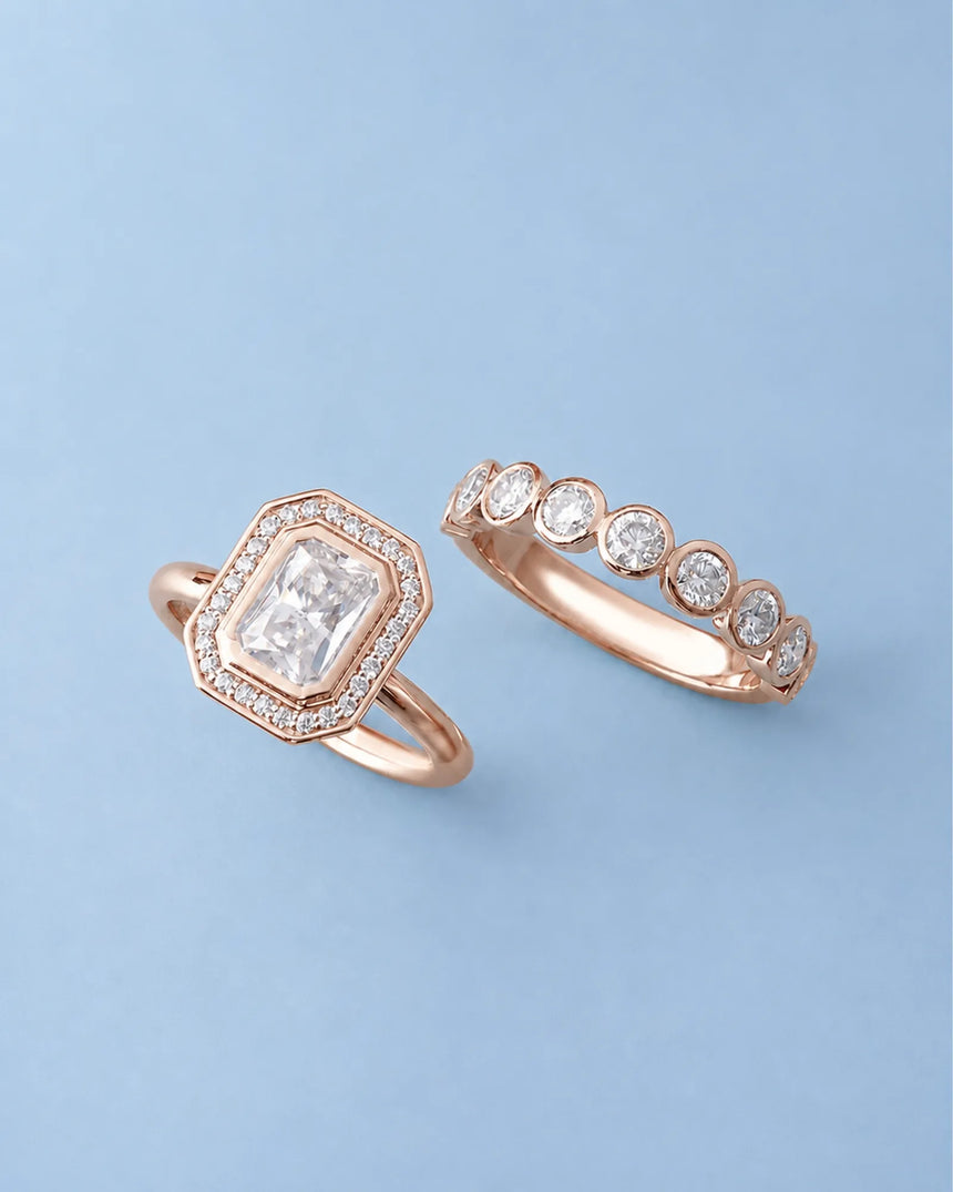 D color radiant moissanite center framed by round moissanite accents in polished 18K rose gold | SARATTI