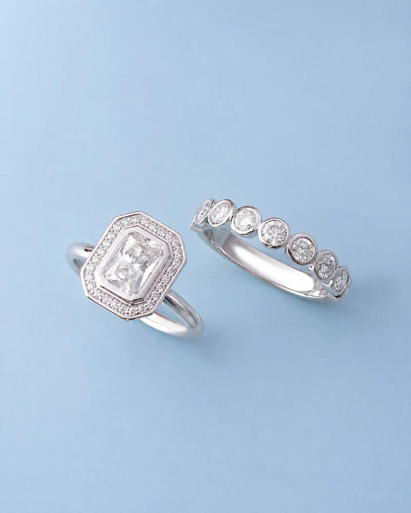 D color radiant moissanite center framed by round moissanite accents in polished 18K white gold | SARATTI