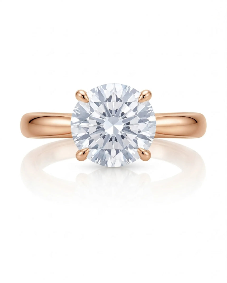 D color round moissanite center with discreet pavé accents in warm 18K rose gold | SARATTI