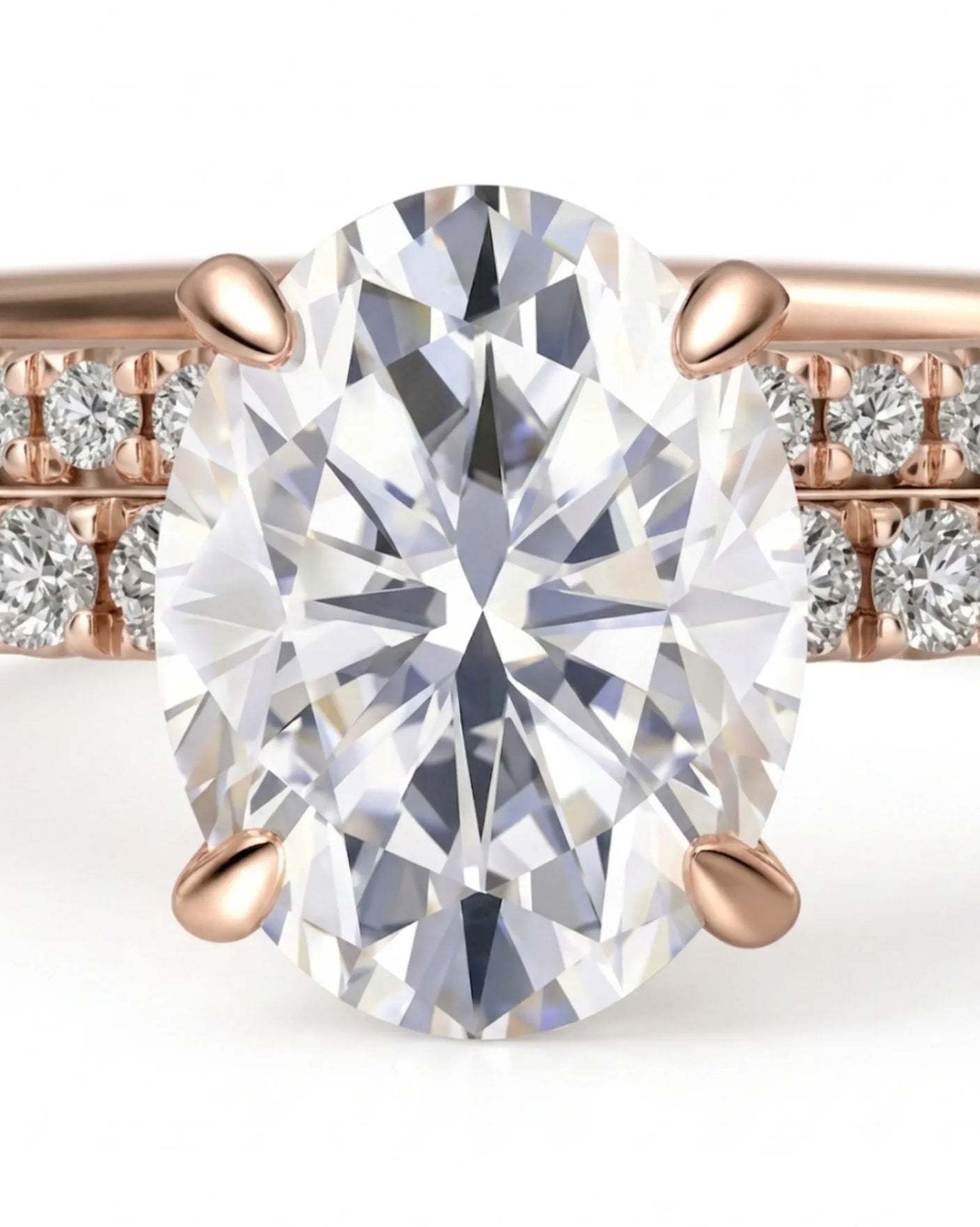 D colorless oval moissanite engagement ring with round accent stones and 18K rose gold wedding band | SARATTI