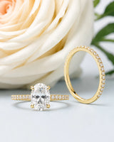 D colorless oval moissanite engagement ring with round accent stones and 18K yellow gold wedding band | SARATTI