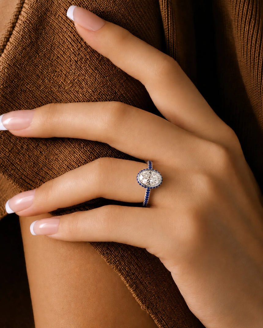 D colorless oval moissanite framed by vivid blue sapphires in enduring polished platinum - SARATTI