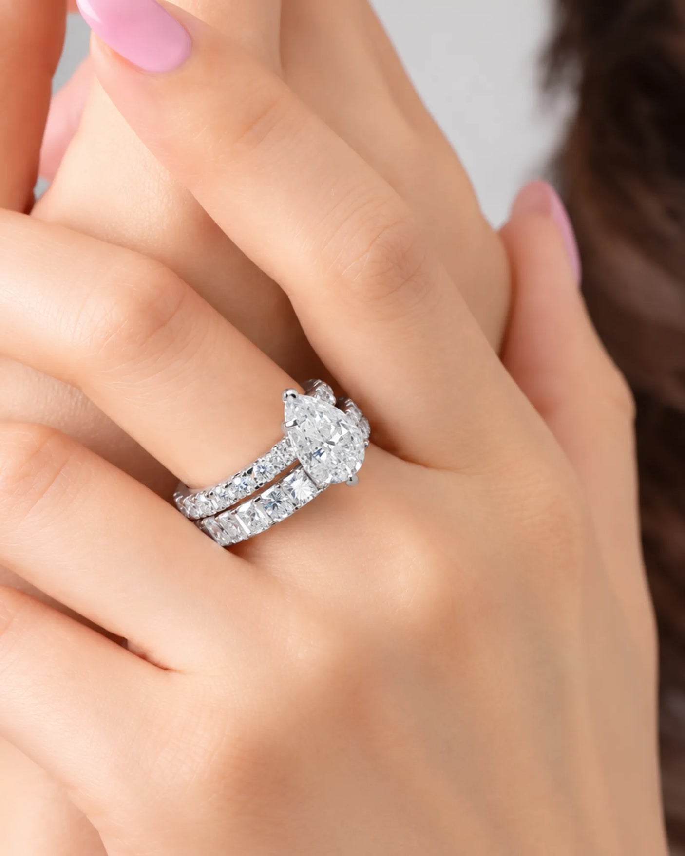 D colorless pear moissanite engagement ring with round accent stones in platinum | SARATTI.
