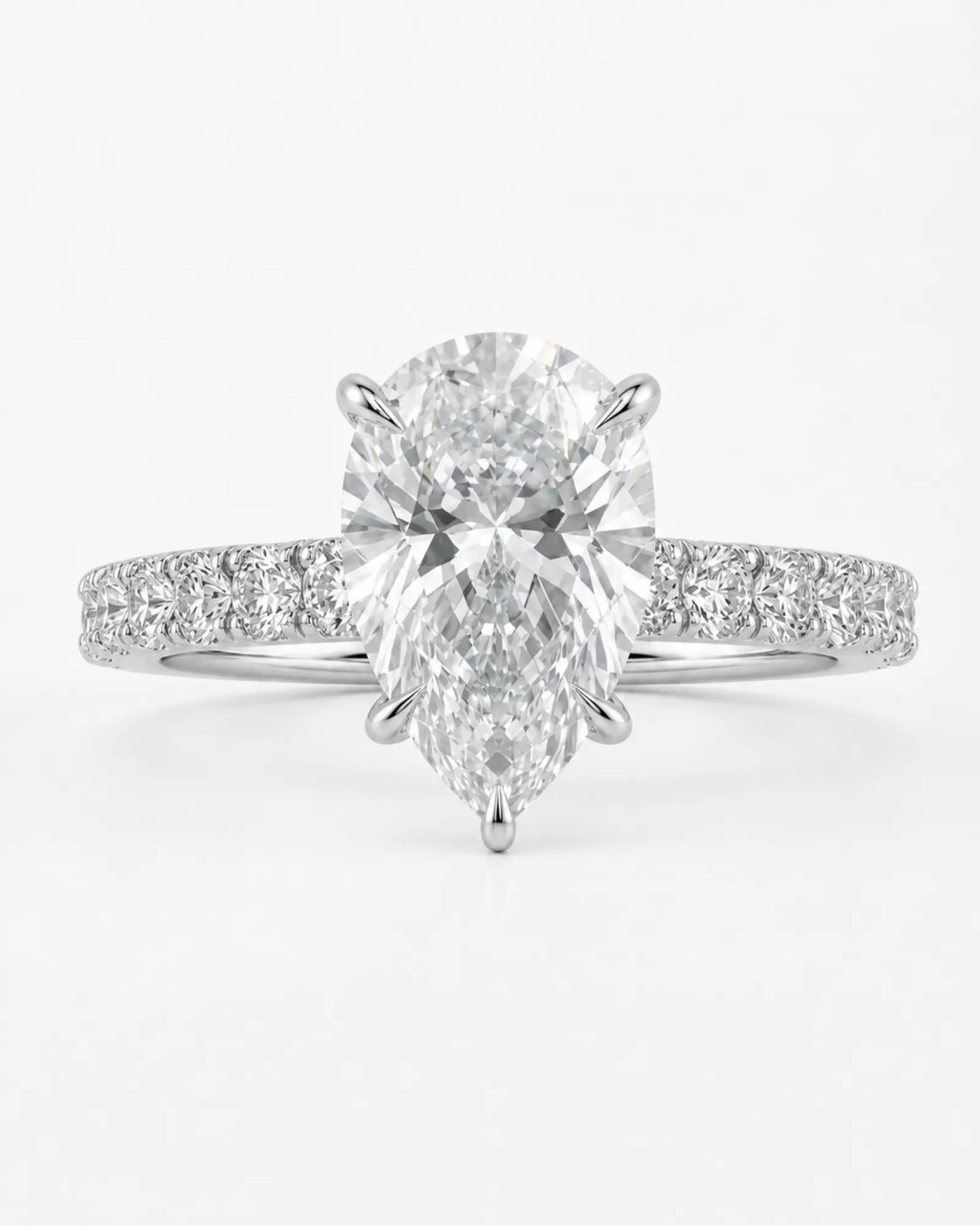 D colorless pear moissanite engagement ring with round accent stones in platinum | SARATTI