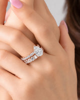 D colorless pear moissanite engagement ring with round accent stones in rose gold | SARATTI.