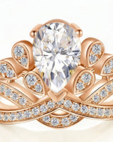 D colorless pear moissanite ring framed by round accent stones in 18K rose gold | SARATTI