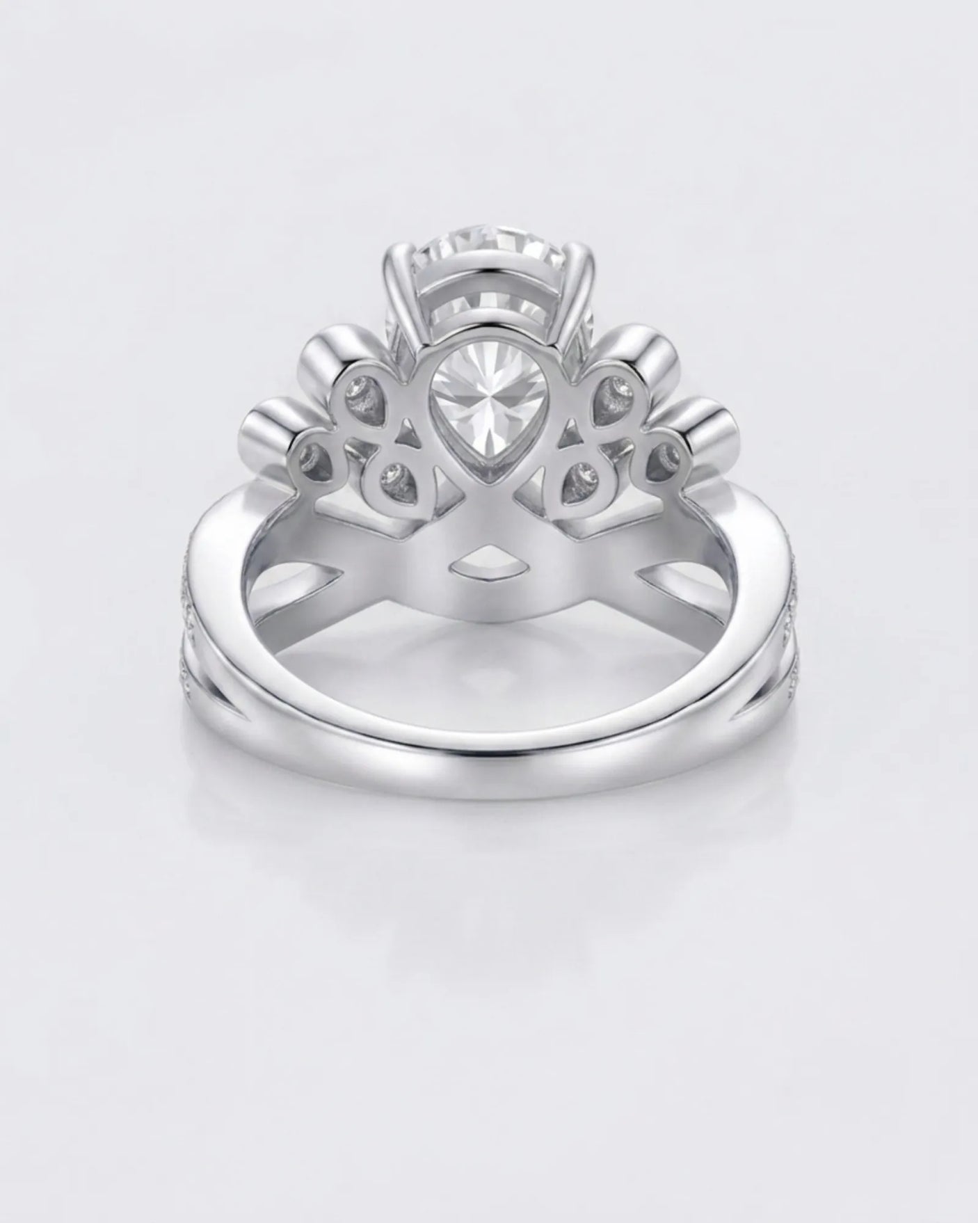 D colorless pear moissanite ring framed by round accent stones in polished platinum | SARATTI
