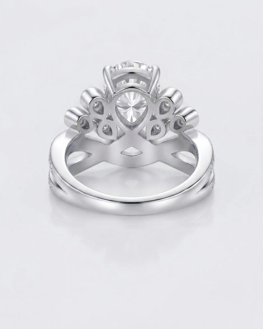 D colorless pear moissanite ring framed by round accent stones in polished platinum | SARATTI