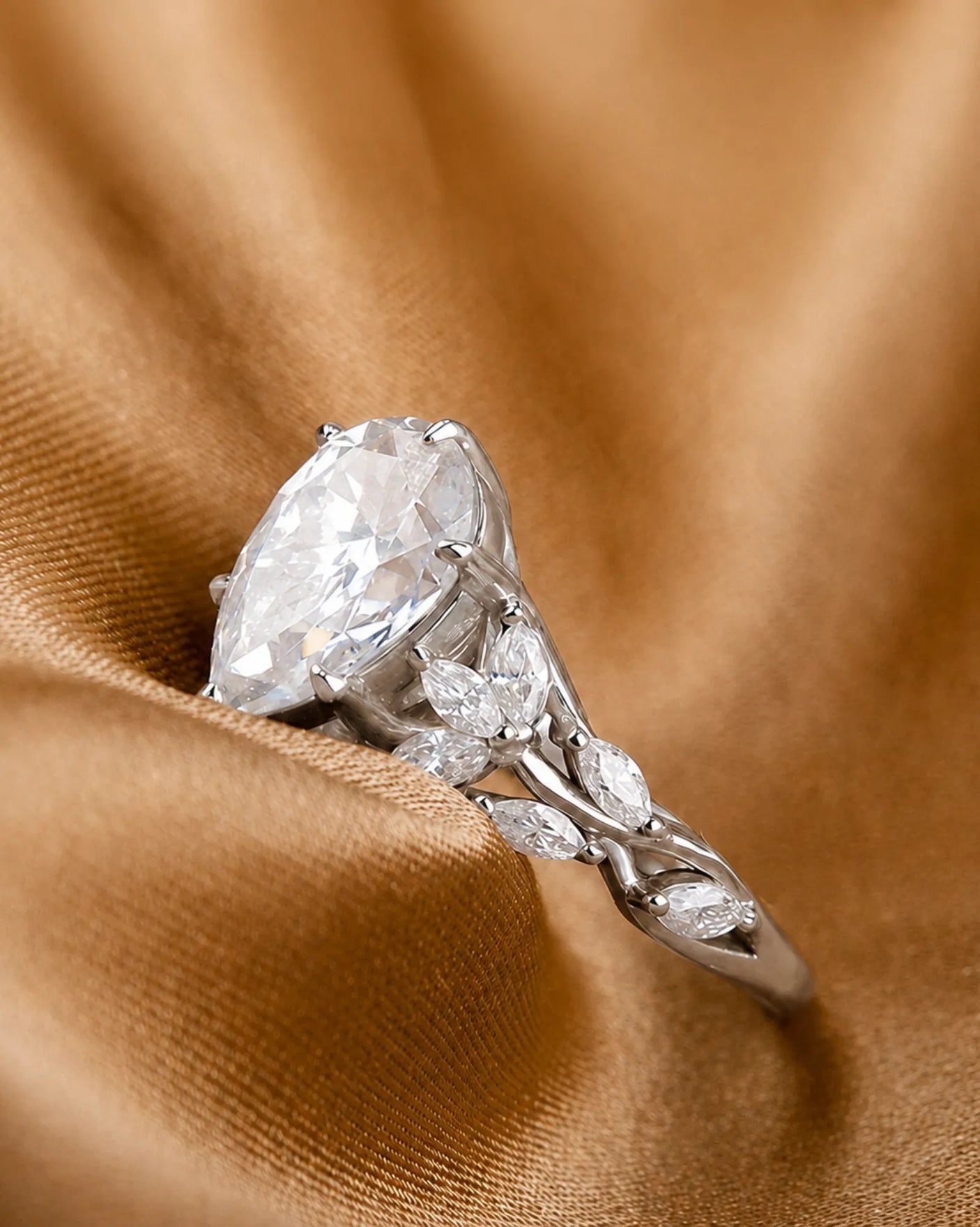 D colorless pear moissanite ring with marquise side stones in polished platinum | SARATTI
