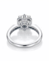 D colorless round moissanite ring with pavé shoulders and intricate fleur-de-lis details in platinum | SARATTI