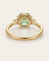 Dainty green tourmaline engagement ring with two diamonds in 18K yellow gold | SARATTI