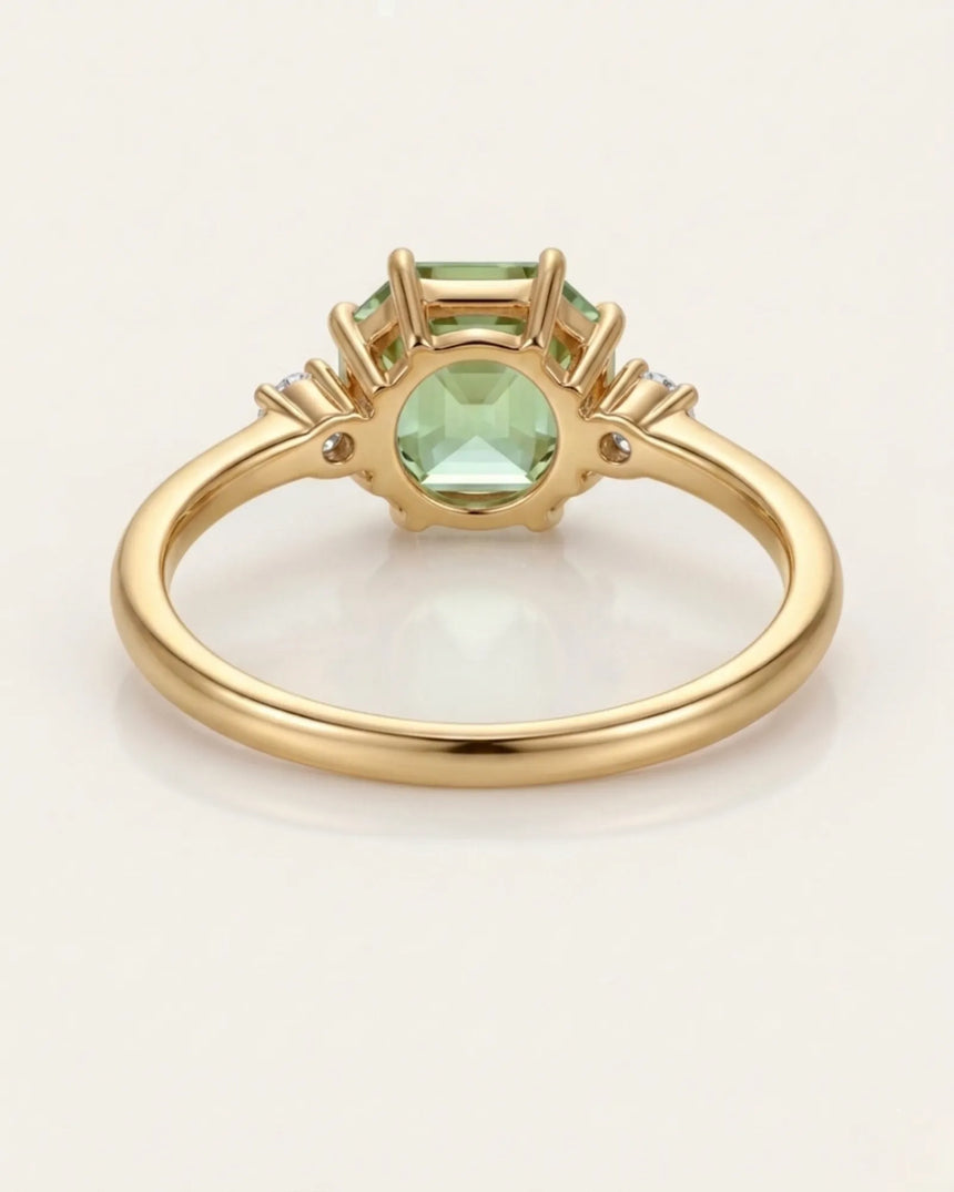 Dainty green tourmaline engagement ring with two diamonds in 18K yellow gold | SARATTI
