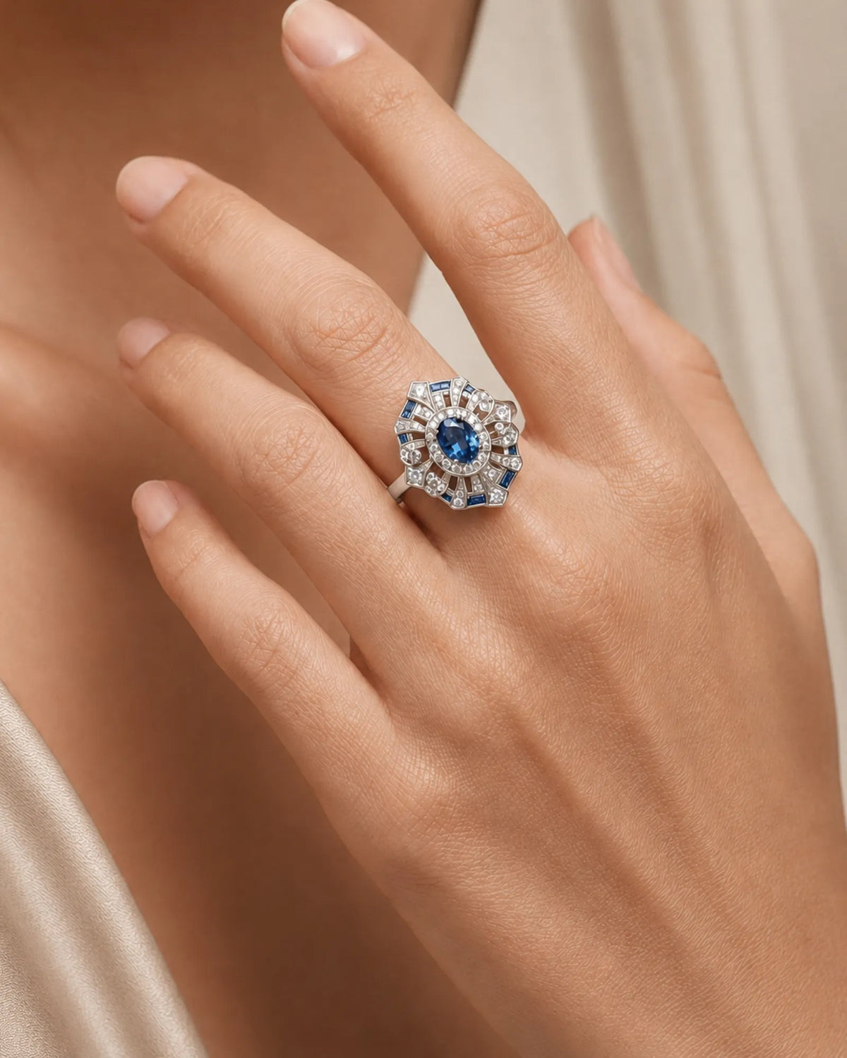 Deep London Blue oval topaz ring framed by round diamonds in 18K white gold | SARATTI