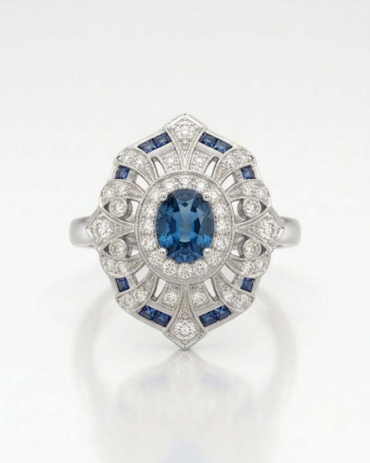 Deep London Blue oval topaz ring framed by round diamonds in platinum | SARATTI