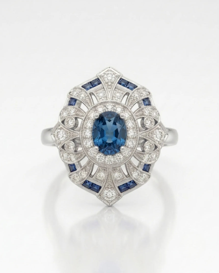 Deep London Blue oval topaz ring framed by round diamonds in platinum | SARATTI