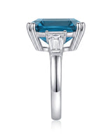 Deep blue Asscher topaz ring framed by tapered baguette diamonds in polished platinum | SARATTI