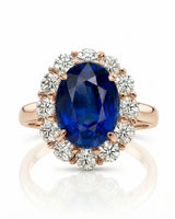Deep blue oval sapphire ring with bright round diamonds in 18K rose gold | SARATTI
