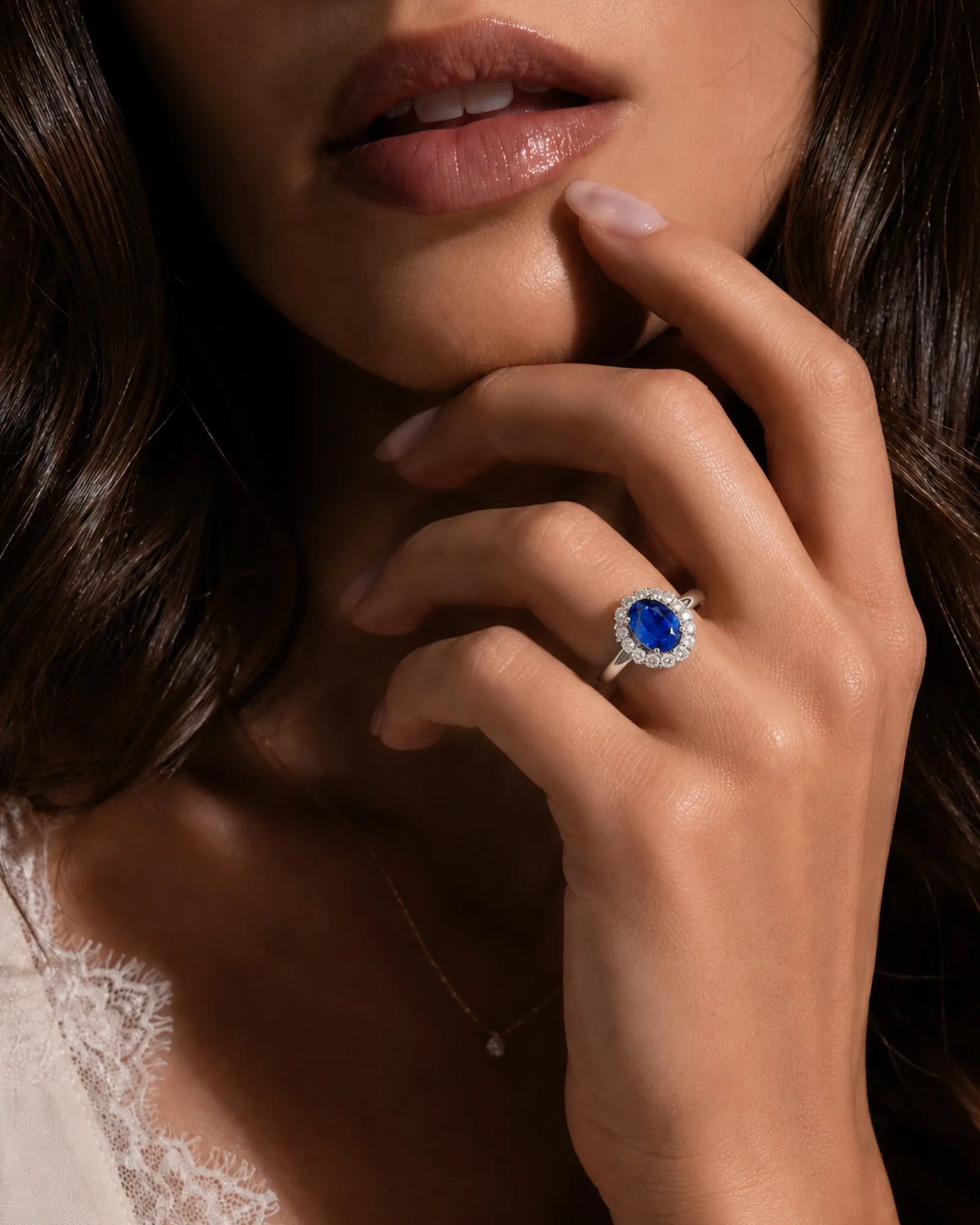 Deep blue oval sapphire ring with bright round diamonds in 18K white gold | SARATTI