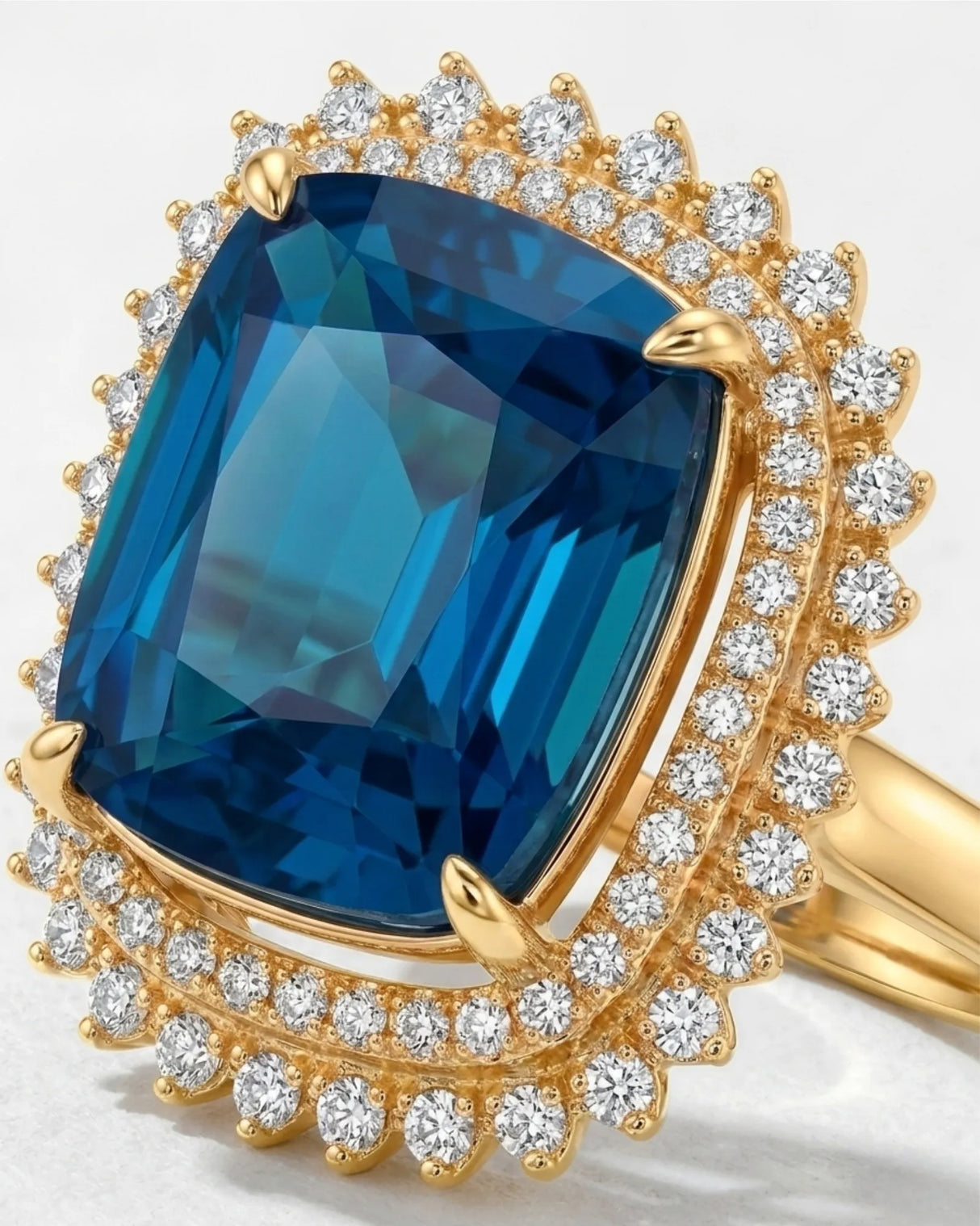 Deep blue tourmaline ring with sparkling diamond halo accents in 18K yellow gold | SARATTI